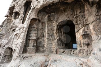 LUOYANG, CHINA - MARCH 20, 2017: carved sculptures and rooms in West Hill of Chinese Buddhist monument Longmen Grottoes. The complex was inscribed upon the UNESCO World Heritage List in 2000