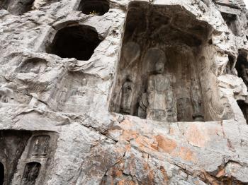 LUOYANG, CHINA - MARCH 20, 2017: relief statues in cave in West Hill of Chinese Buddhist monument Longmen Grottoes. The complex was inscribed upon the UNESCO World Heritage List in 2000