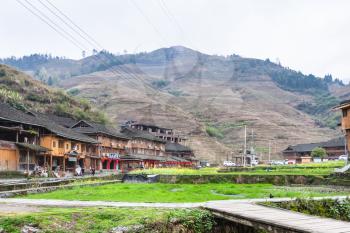 DAZHAI, CHINA - MARCH 23, 2017: square and houses in Dazhai Longsheng village in spring. This is central village in famous scenic area of Longji Rice Terraces in China