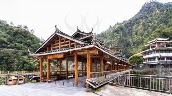 JIANGDI, CHINA - MARCH 26, 2017: view of to Dong people style bridge and spa hotel in Jiangdi village in resort area Longsheng Hot Springs National Forest Park of Xiangshan District