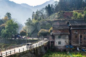 CHENGYANG, CHINA - MARCH 27, 2017: view of people near bus stop and road to Chengyang village Sanjiang Country. In Chengyang there are eight villages and several Fengyu Bridges of the Dong people