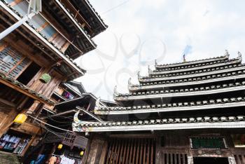CHENGYANG, CHINA - MARCH 27, 2017: Pagoda and market in Folk Custom Centre of Chengyang village of Sanjiang Dong Autonomous County in spring. Chengyang includes eight villages of the Dong people
