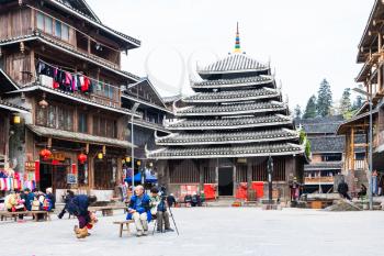 CHENGYANG, CHINA - MARCH 27, 2017: tourists on square in Folk Custom Centre of Chengyang village of Sanjiang Dong Autonomous County in spring. Chengyang includes eight villages of the Dong people