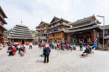 CHENGYANG, CHINA - MARCH 27, 2017: tourists on square of Folk Custom Centre during Dong Culture Show of Chengyang village of Sanjiang County in spring. Chengyang includes eight villages of Dong people