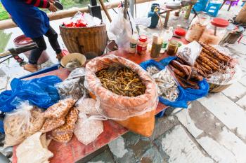 CHENGYANG, CHINA - MARCH 27, 2017: stall with snacks on local market in Chengyang village of Sanjiang Dong Autonomous County in spring. Chengyang includes eight villages of the Dong people