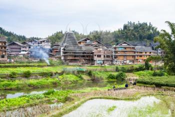 CHENGYANG, CHINA - MARCH 27, 2017: people on gardens in Chengyang village of Sanjiang Dong Autonomous County in spring. Chengyang includes eight villages of the Dong people