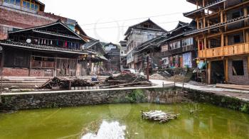 CHENGYANG, CHINA - MARCH 27, 2017: canal and street near residential houses in Chengyang village of Sanjiang Dong Autonomous County in spring. Chengyang includes eight villages of the Dong people