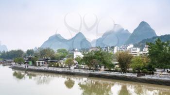 YANGSHUO, CHINA - MARCH 29, 2017: waterfront of Yulong river in Yangshuo town county in spring. Town is resort destination for domestic and foreign tourists because of scenic karst peaks