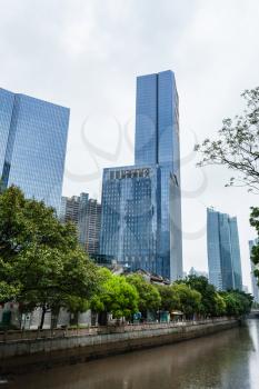 GUANGZHOU, CHINA - MARCH 31, 2017: skyscrapers on embankment in Zhujiang New Town of Guangzhou city in spring rain. Guangzhou is the third most-populous city in China with population about 13,5 mln