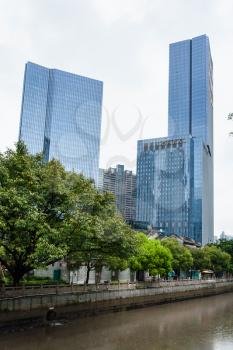 GUANGZHOU, CHINA - MARCH 31, 2017: skyscrapers on quay in Zhujiang New Town of Guangzhou city in spring rainy day. Guangzhou is the third most-populous city in China with population about 13,5 mln
