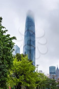 GUANGZHOU, CHINA - MARCH 31, 2017: fog over skyscraper in Zhujiang New Town of Guangzhou city in rainy day. Guangzhou is the third most-populous city in China with population about 13,5 mln