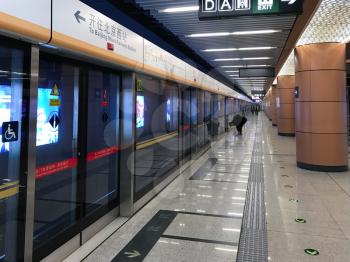 BEIJING, CHINA - MARCH 19, 2017: people near subway car on Zhushikou station of Beijing underground. The urban rail network has 19 lines, 345 stations and 574 km of track in operation
