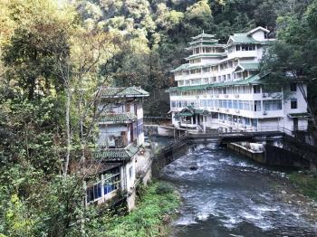 JIANGDI, CHINA - MARCH 26, 2017: view of spa resort hotel near mountain river in Jiangdi village in Longsheng Hot Springs National Forest Park of Xiangshan District in spring season