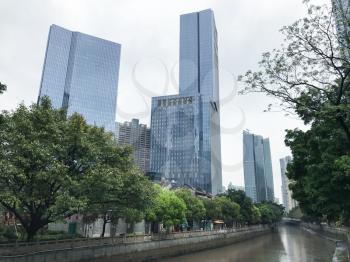 GUANGZHOU, CHINA - MARCH 31, 2017: skyscrapers on waterfront in Zhujiang New Town of Guangzhou city in spring rainy day. Guangzhou is the third most-populous city in China with population about 13,5 m