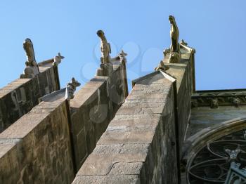 Travel to Occitanie, France - gargoyles on wall of Basilica of Saints Nazarius and Celsus (Eglise Saint-Nazaire de Carcassonne, Basilique Saint Nazaire) in Cite de Carcassonne
