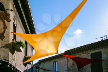 Travel to Occitanie, France - flags on street in medieval town Cite de Carcassonne