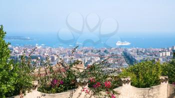 Travel to Provence, France - green flowerbed in garden and view of cote d'azur and Cannes city on background
