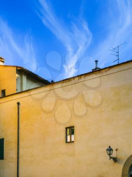 travel to Italy - yellow urban house under blue sky in Florence city in sunny winter day