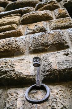travel to Italy - ring of hitching post on wall of medieval house on street in Florence city