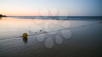 Travel to Algarve Portugal - buoy on beach Praia Falesia near Albufeira city during evening ebb