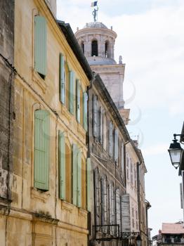Travel to Provence, France - residential houses on street Rue de la Calade and view of Town Hall Tower in Arles city