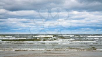 travel to Latvia - low gray clouds over water of Gulf of Riga of Baltic Sea in seaside resort Jurmala town in autumn