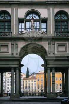 travel to Italy - view of Uffizi Galery building and houses on waterfront Arno river in Florence city in winter day
