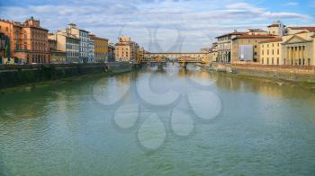 travel to Italy - panoramic view of Arno River with Ponte Vecchio (old bridge) in Florence city in sunny winter day