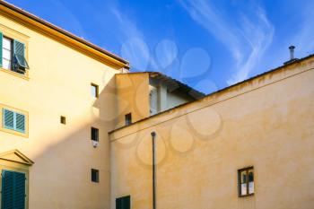 travel to Italy - yellow apartment house under blue sky in Florence city in sunny winter day