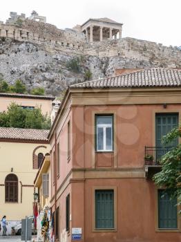 ATHENS, GREECE - SEPTEMBER 9, 2007: people on road to Athenian Acropolis in historical neighborhood Plaka in Athens city. Acropolis of Athens is ancient citadel located on rock above the city