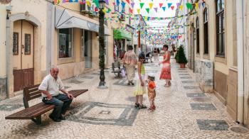 SILVES, PORTUGAL - JUNE 27, 2006: people on street Rua Elias Garcia in center of Sives city. Silves town is the former capital of the Algarve region, it ihas great historical significance