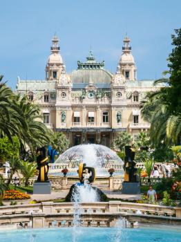 MONTE CARLO, MONACO - JULY 6, 2008: tourists near fountain and view of Casino de Monte-Carlo in Monaco city. Principality of Monaco is sovereign city-state and country located on the French Riviera