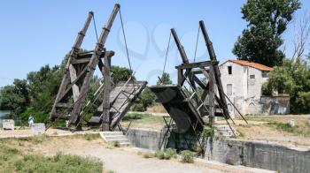 ARLES, FRANCE - JULY 7, 2008: tourists near Pont Van Gogh, replica of the Langlois Bridge, drawbridge which was the subject of several paintings by Vincent van Gogh in 1888, on Canal d'Arles a Fos