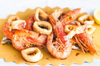 typical italian food - plate with roasted local seafood in sicilian restaurant