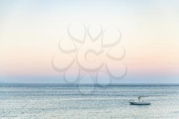 travel to Sicily, Italy - view of boat in Ionian sea near Giardini Naxos town in summer evening