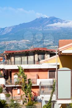 travel to Sicily, Italy - residential quarter on street via ischia in Giardini Naxos town and view of Etna Mount in summer
