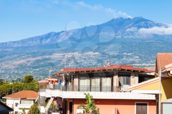 travel to Sicily, Italy - residential houses on street via ischia in Giardini Naxos town and view of Etna Mount in summer