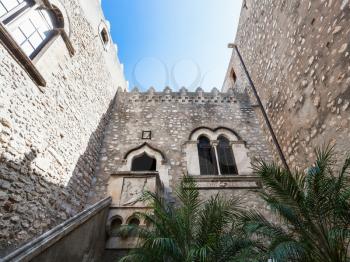 travel to Sicily, Italy - inner public courtyard of Corvaja Palace in Taormina city. Palazzo Corvaja is a medieval palace dating from the 10th century
