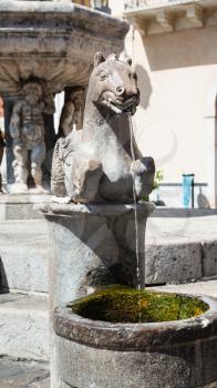travel to Sicily, Italy - detail of baroque style fountain (4 Fontane of Taormina) on Piazza Del Duomo in Taormina city in summer day