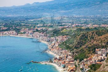 travel to Sicily, Italy - above view of Giardini Naxos town of beach of Ionian Sea from Taormina city in summer day