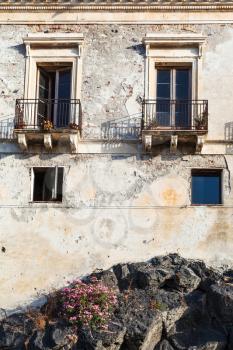 travel to Sicily, Italy - old urban house on volcanic rock base in Giardini Naxos town in summer