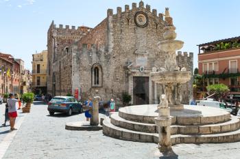 TAORMINA, ITALY - JUNE 29, 2017: tourists on Piazza dell Duomo near fountain in Taormina city. Taormina is resort town on Ionian Sea in Sicily