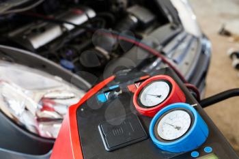 Refilling of car air conditioner in auto repair shop