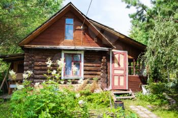 front view of log house in russian village in sunny summer day