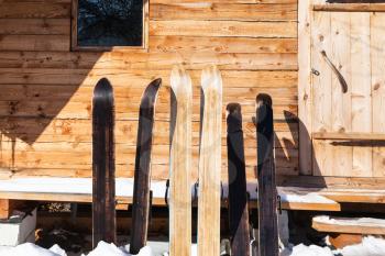wide forest skis in front of wooden cottage in sunny winter day in russian village in Smolensk region of Russia