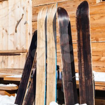 wide forest skis near door of wooden cottage in winter in russian village in Smolensk region of Russia