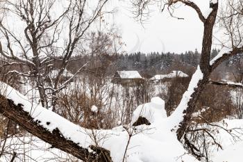 winter scenic of old little russian village in overcast day in Smolensk region of Russia