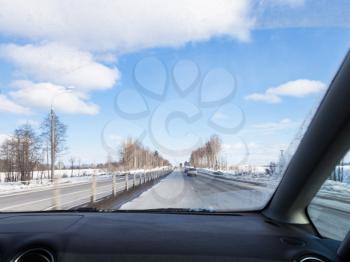 driving along M1 highway (Russian route M1, Belarus Highway, European route E30) in Smolensk oblast of Russia in wither day