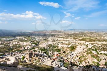 Travel to Turkey - blue sky over Uchisar village and valley in Nevsehir Province in Cappadocia in spring