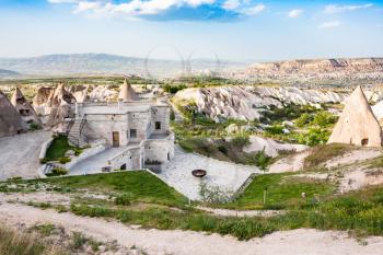 Travel to Turkey - modern and ancient rock-cut houses in Uchisar village in Cappadocia in spring